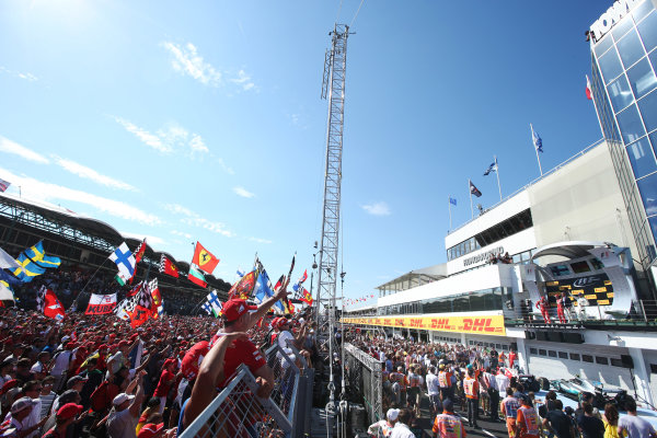 Hungaroring, Budapest, Hungary. 
Sunday 30 July 2017.
Fans cheer for Sebastian Vettel, Ferrari, 1st Position, Kimi Raikkonen, Ferrari, 2nd Position, and Valtteri Bottas, Mercedes AMG, 3rd Position, on the podium.
World Copyright: Charles Coates}/LAT Images 
ref: Digital Image AN7T9833