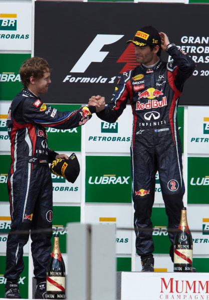 Interlagos, Sao Paulo, Brazil.
27th November 2011.
Sebastian Vettel, Red Bull Racing RB7 Renault, 2nd position, congratulates Mark Webber, Red Bull Racing RB7 Renault, 1st position, on the podium. Portrait. Podium. 
World Copyright: Steve Etherington/LAT Photographic
ref: Digital Image SNE28309