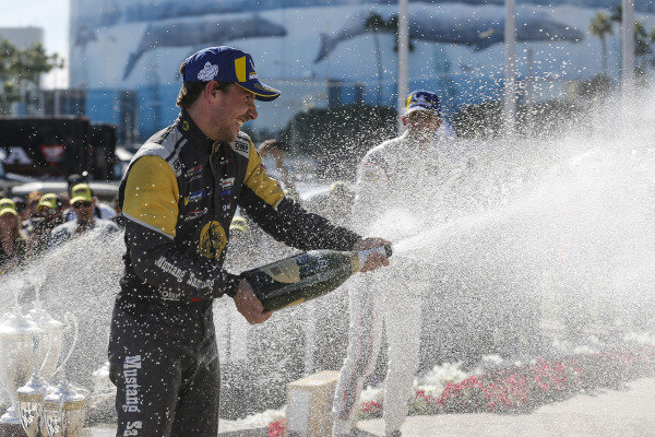 #5 Mustang Sampling Racing Cadillac DPi, DPi: Joao Barbosa, Filipe Albuquerque, #6 Acura Team Penske Acura DPi, DPi: Juan Pablo Montoya, Dane Cameron, #7 Acura Team Penske Acura DPi, DPi: Helio Castroneves, Ricky Taylor celebrate on the podium with champagne #5 Mustang Sampling Racing Cadillac DPi, DPi: Joao Barbosa, Filipe Albuquerque, #6 Acura Team Penske Acura DPi, DPi: Juan Pablo Montoya, Dane Cameron, #7 Acura Team Penske Acura DPi, DPi: Helio Castroneves, Ricky Taylor celebrate on the podium with champagne