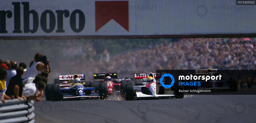 Ayrton Senna, McLaren MP4-6 Honda, with sparks flying as he brakes, leads Riccardo Patrese, Williams FW14 Renault, Alain Prost, Ferrari 643, and Nigel Mansell, Williams FW14 Renault, into the first corner at the start. Ayrton Senna, McLaren MP4-6 Honda, with sparks flying as he brakes, leads Riccardo Patrese, Williams FW14 Renault, Alain Prost, Ferrari 643, and Nigel Mansell, Williams FW14 Renault, into the first corner at the start.