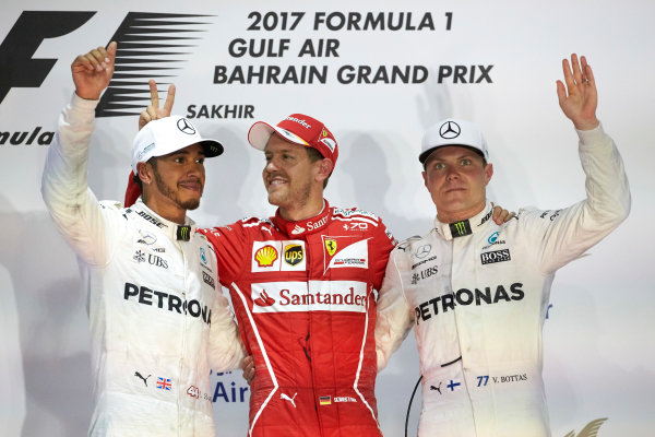 Bahrain International Circuit, Sakhir, Bahrain. 
Sunday 16 April 2017.
Lewis Hamilton, Mercedes AMG, 2nd Position, Sebastian Vettel, Ferrari, 1st Position, and Valtteri Bottas, Mercedes AMG, 3rd Position, on the podium.
World Copyright: Steve Etherington/LAT Images
ref: Digital Image SNE23075