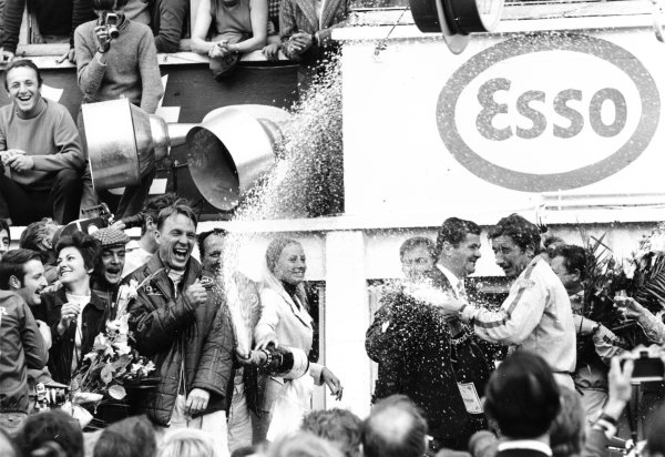 Le Mans, France.10-11 June 1967.Dan Gurney and AJ Foyt (Ford) celebrate finishing in 1st position with Jo Siffert (Porsche, right with champagne) and Jean Marie Dubois of Moet. This was the first time champagne was sprayed in celebration.Published-Autocar 15/6/1967 p15.World Copyright - LAT Photographic Le Mans, France.10-11 June 1967.Dan Gurney and AJ Foyt (Ford) celebrate finishing in 1st position with Jo Siffert (Porsche, right with champagne) and Jean Marie Dubois of Moet. This was the first time champagne was sprayed in celebration.Published-Autocar 15/6/1967 p15.World Copyright - LAT Photographic