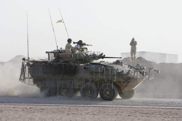 2007 Australian V8 Supercars.
Bahrain International Circuit. Sakhir, Bahrain.
2nd - 4th November. 
Kelly and Greg Murphy race against Craig Lowndes and Jason Bright  in a pair of armored troop carriers  during a visit to the Australian troops based at Tallil Airbase located approximately 310 kilometers Southeast of Baghdad. 
World Copyright: Mark Horsburgh/LAT Photographic. 
Ref: Digital Image V8-Drivers-IRAQ-6979