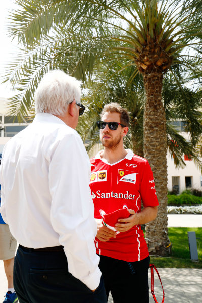 Bahrain International Circuit, Sakhir, Bahrain. 
Thursday 13 April 2017.
Sebastian Vettel, Ferrari, talks with Charlie Whiting, Race Director, FIA, in the paddock.
World Copyright: Sam Bloxham/LAT Images
ref: Digital Image _J6I8351