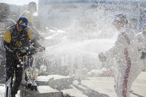 #5 Mustang Sampling Racing Cadillac DPi, DPi: Joao Barbosa, Filipe Albuquerque, #6 Acura Team Penske Acura DPi, DPi: Juan Pablo Montoya, Dane Cameron, #7 Acura Team Penske Acura DPi, DPi: Helio Castroneves, Ricky Taylor celebrate on the podium with champagne